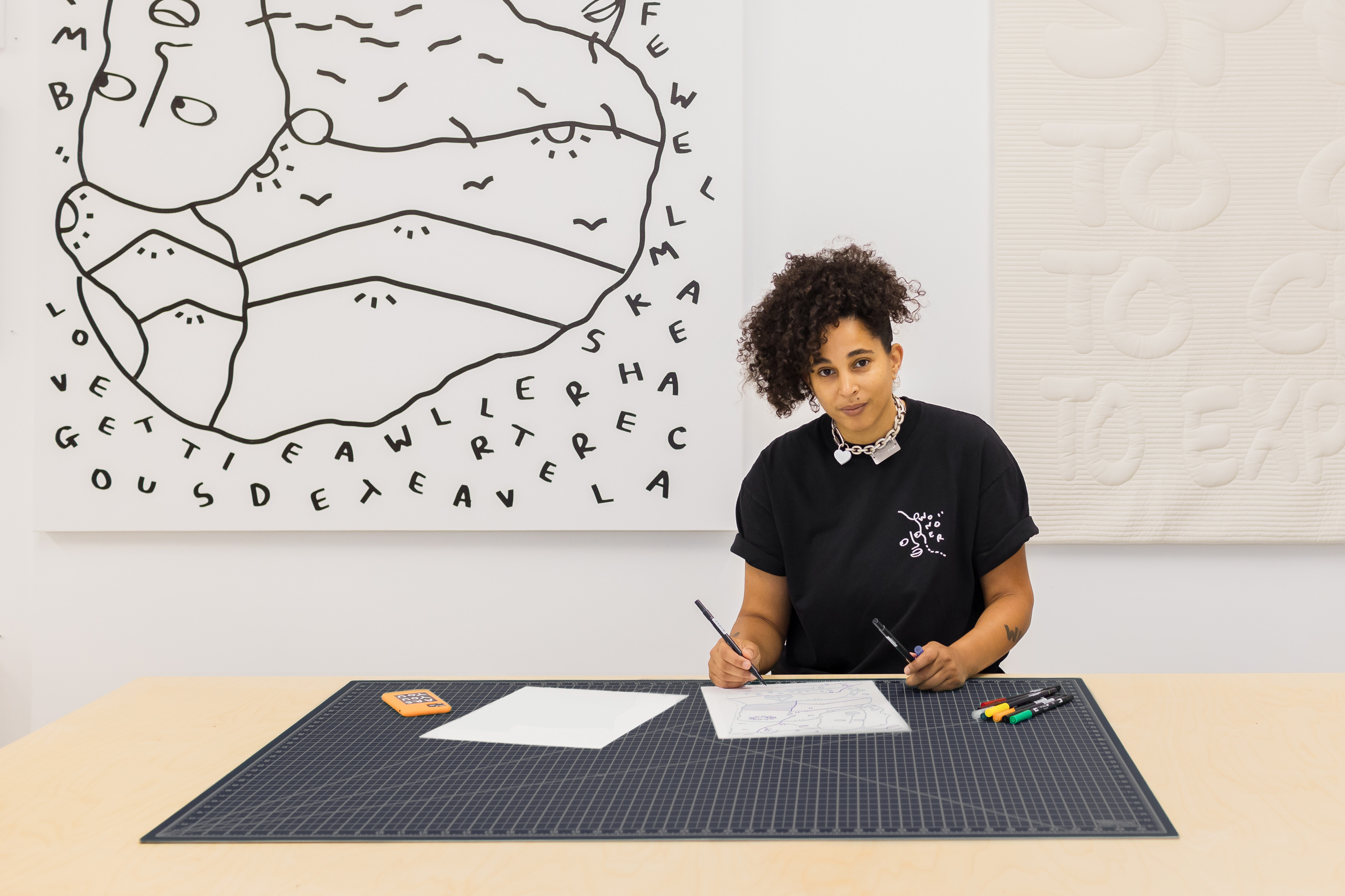 Shantell Martin drawing on a piece of paper